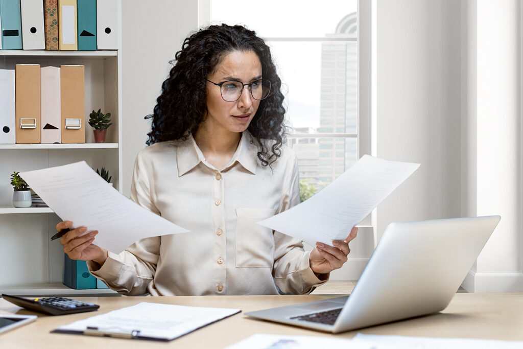Woman sorting financial paperwork needing guidance on property ownership in Japan