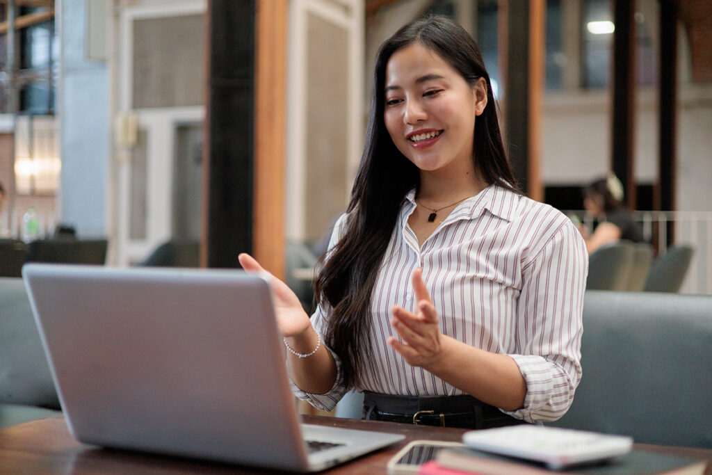 Asian businesswoman having video call on laptop