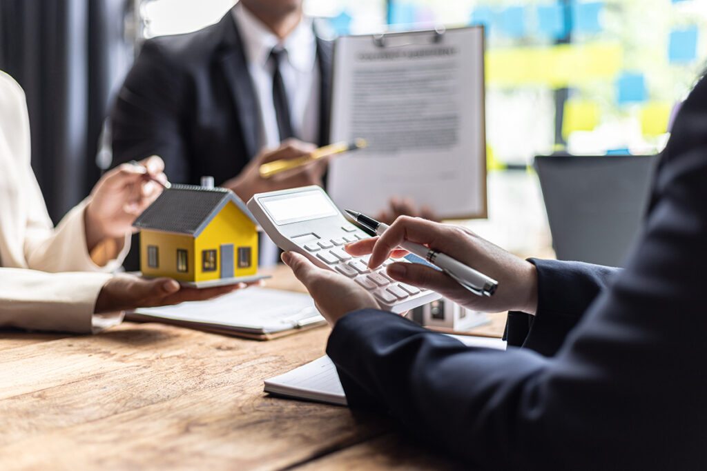 Real estate agent calculates property value with customer